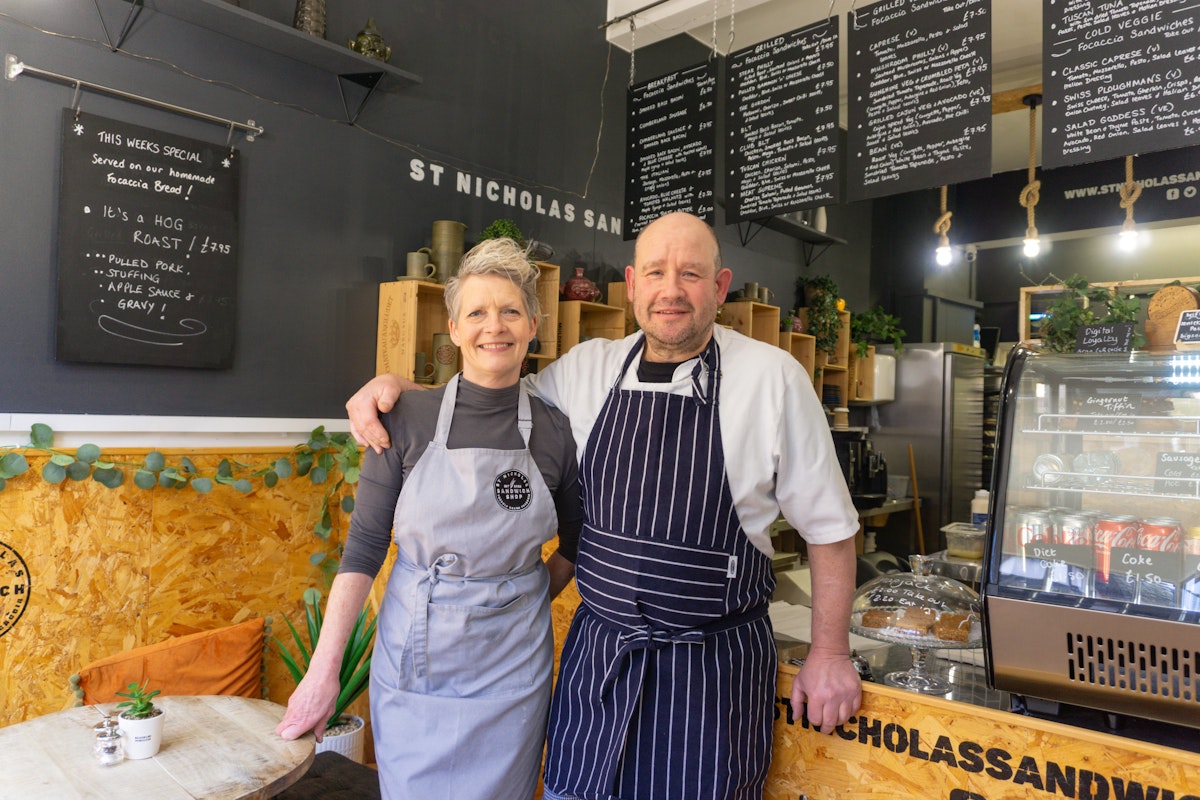 Katrina & Andy owners of St Nicholas Street Sandwich Shop posing inside the shop